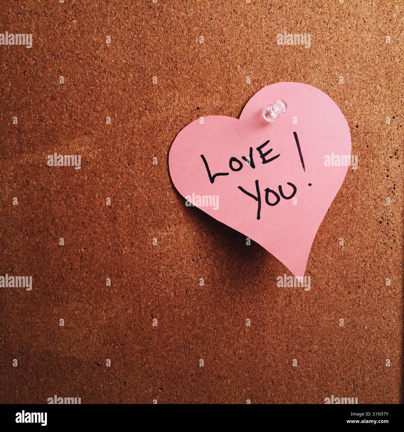 A Heart Shaped Note With The Words I Love You Written On It Pinned To A Cork Board A Heart Shaped Note With The Words I Love You Written On It Pinned To A Cork Board