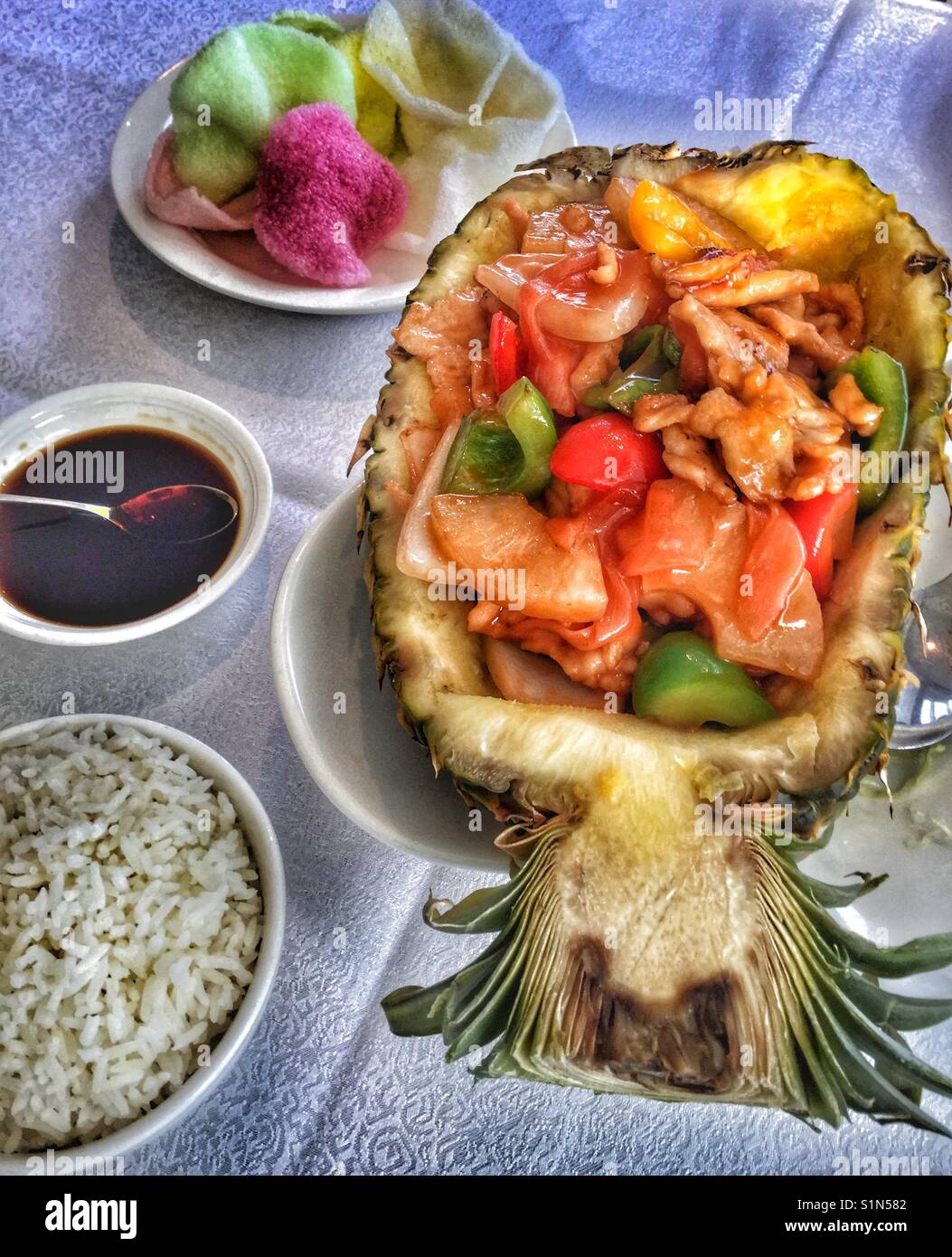 Ginger chicken served in a sliced pineapple. - Smartphone Captured Stock Image