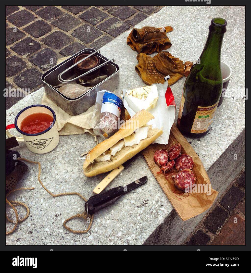 Cycle touring in France, our typical lunch, cidre, bread, cheese and sausage Stock Photo