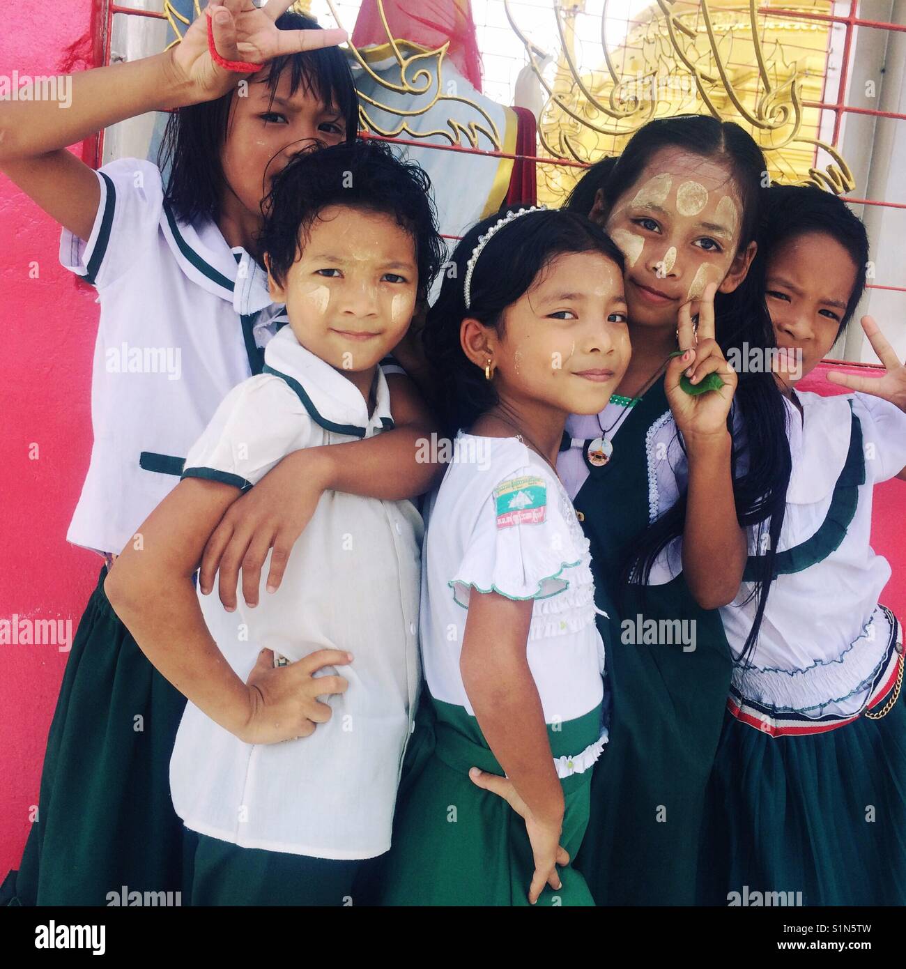 Burmese girls pose for a photograph in Myawaddy, Myanmar. Stock Photo