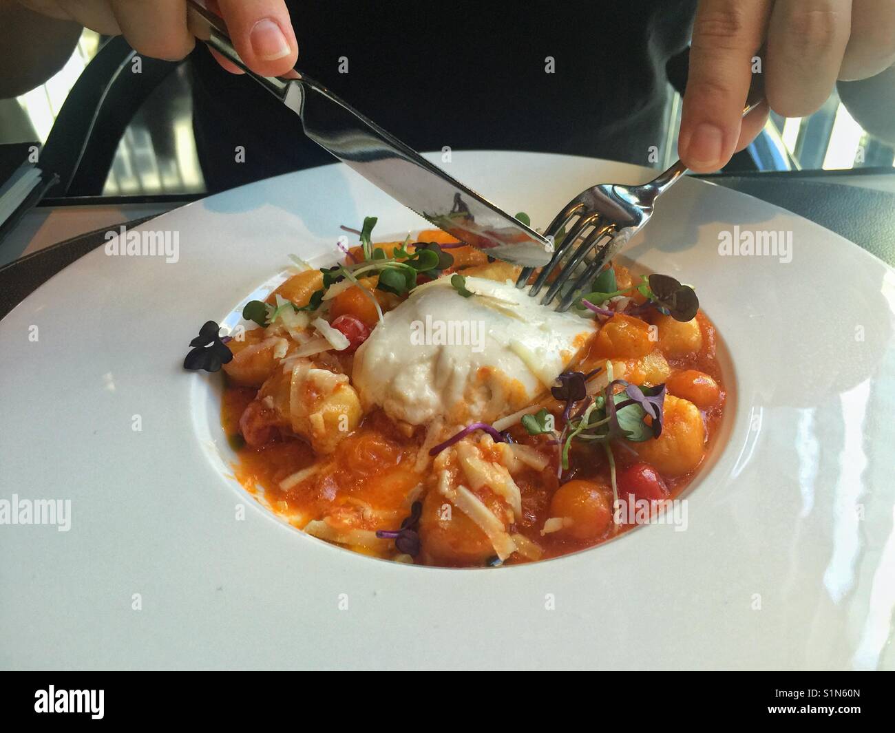 Gnocchi with tomatoes sauce and burrata cheese Stock Photo Alamy