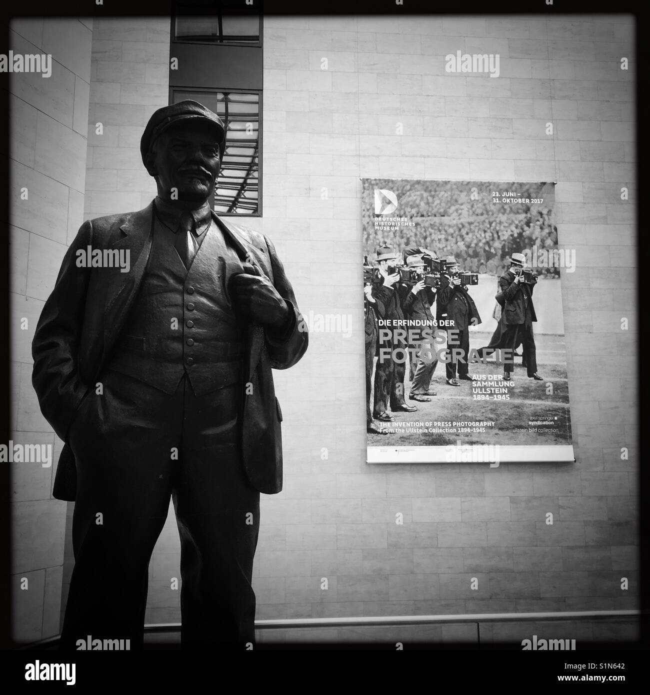Lenin statue in Deutsche Historiche Museum in Berlin with Press photography poster in background Stock Photo