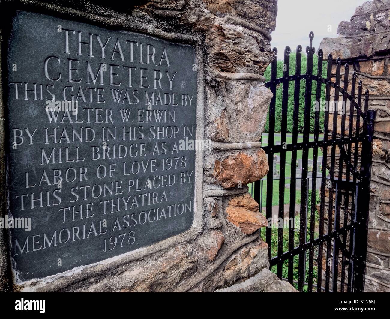 Sign stating Gate made by Walter W. Erwin Thyatira cemetery in Millbridge, North Carolina as a labor of love is on stone column supporting wrought iron gate - North Carolina Stock Photo