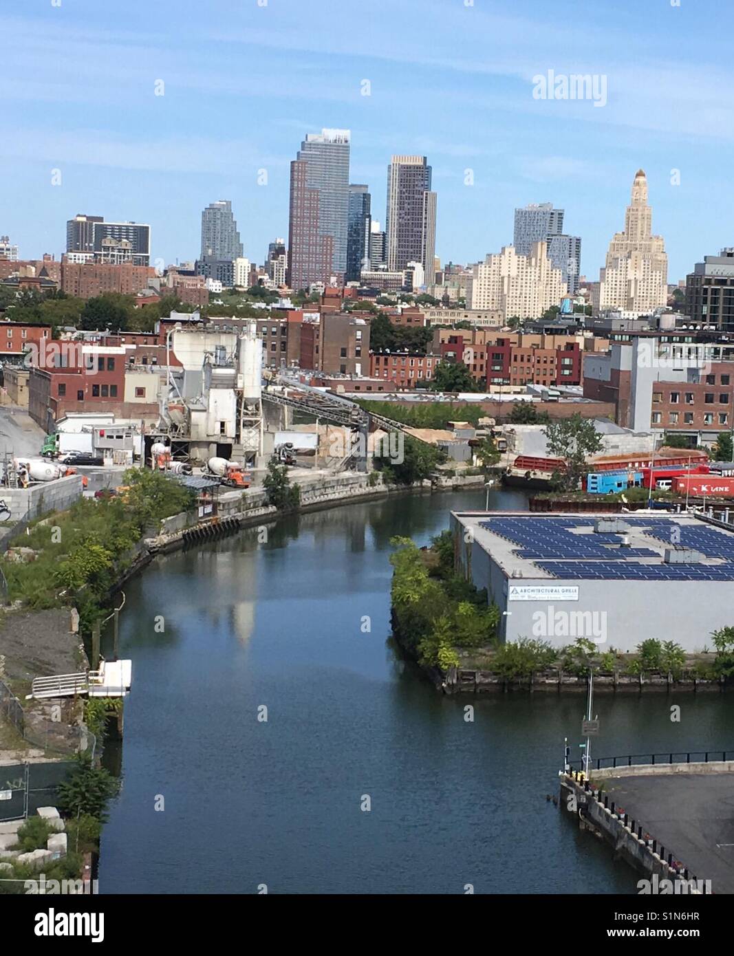 Looking down the Gowanus Canal with newer tall buildings on horizon in Brooklyn, New York. - Smartphone Captured Stock Image
