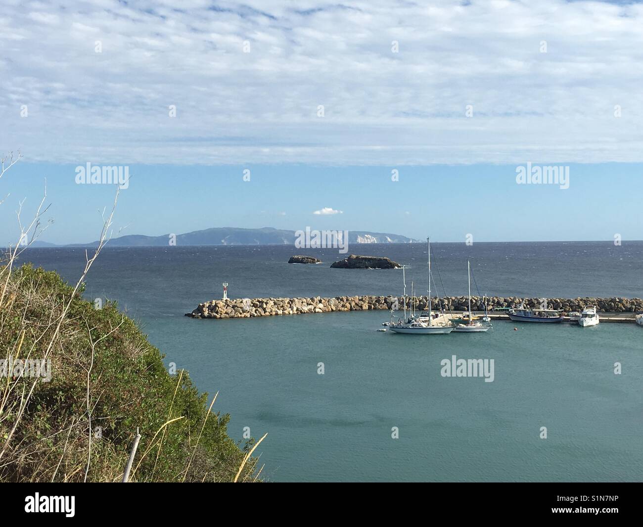 Port of Svornata on Kefalonia in Greece with Zakynthos in the background - Smartphone Captured Stock Image