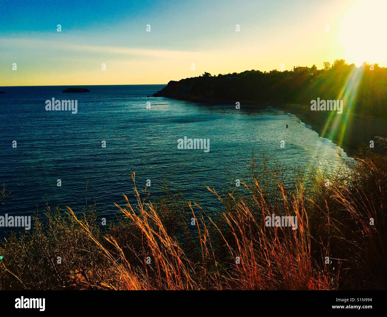 View of sunset and Ionian Sea from above Ai Helis beach on island of Kefalonia in Greece - Smartphone Captured Stock Image