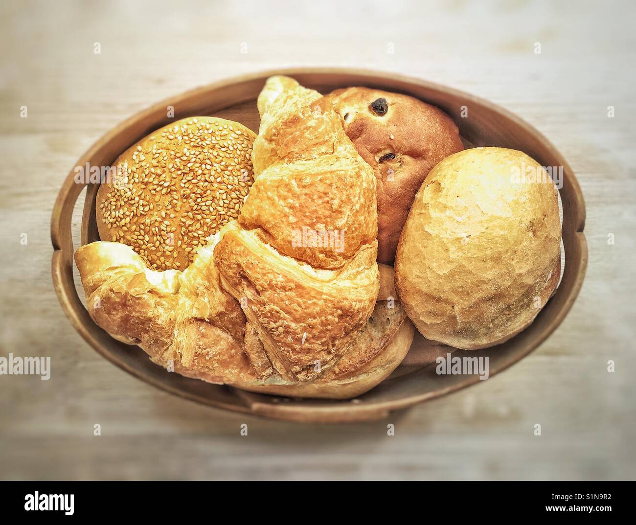 Typical german breakfast bread basket with a Croissant and several