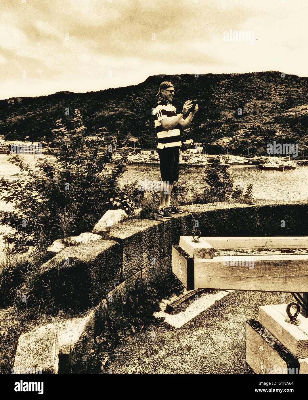 Middle aged Scandinavian man taking photo on mobile, Canada - Smartphone Captured Stock Image