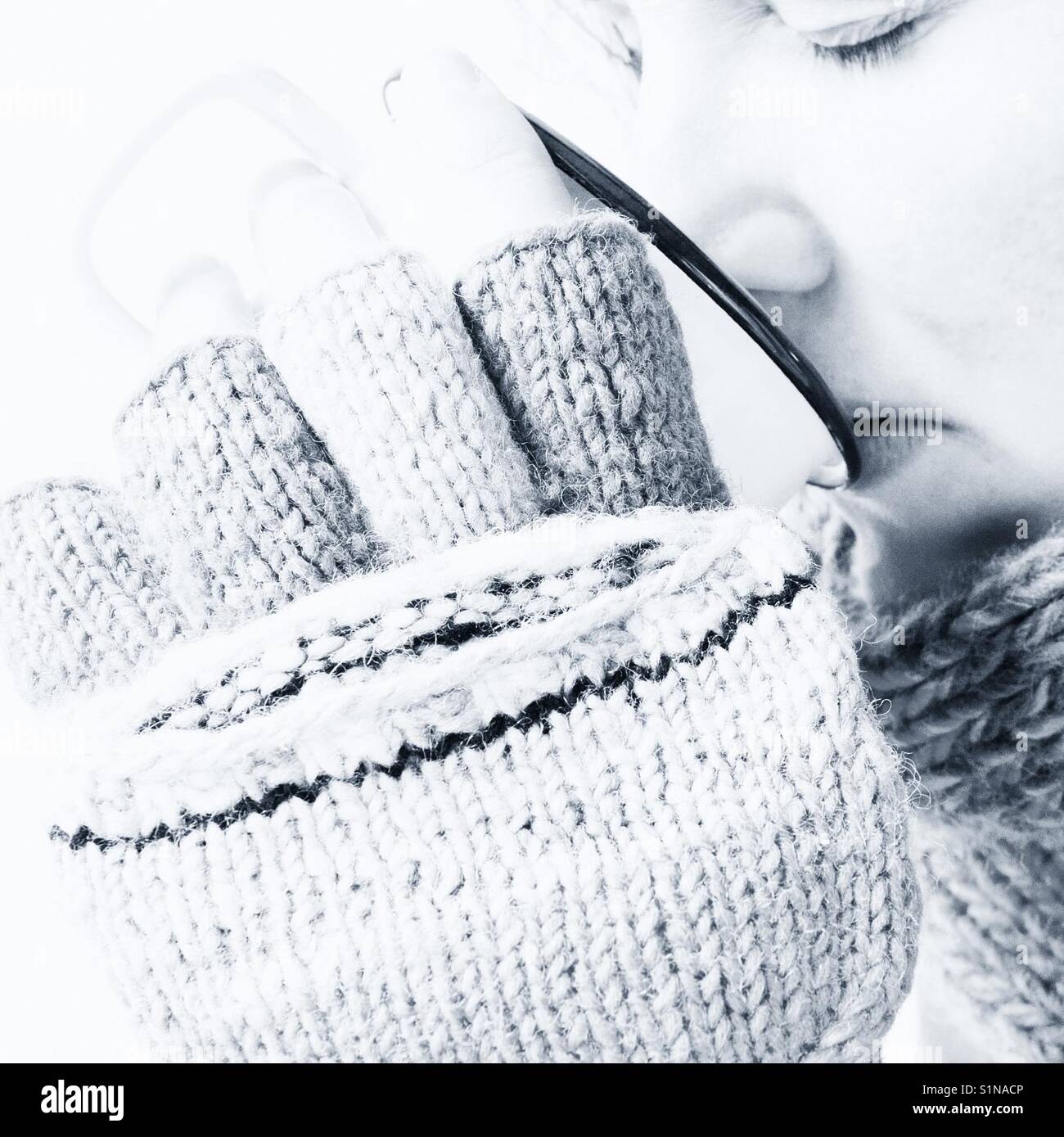 Portrait of a woman drinking from an enamel mug in winter - Smartphone Captured Stock Image