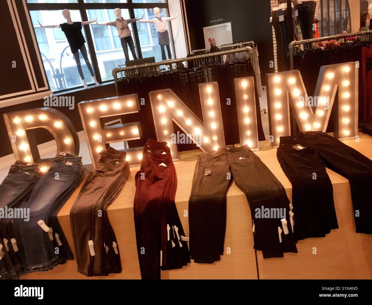 Large bright Denim display featuring lighted sign and many pairs of jeans, Retail store, USA  Lord & Taylor department store New York City - Smartphone Captured Stock Image