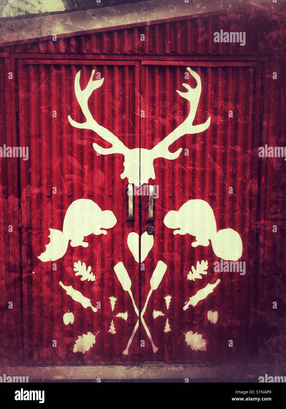 Shed painted red with white iconic Canadian symbols. - Smartphone Captured Stock Image