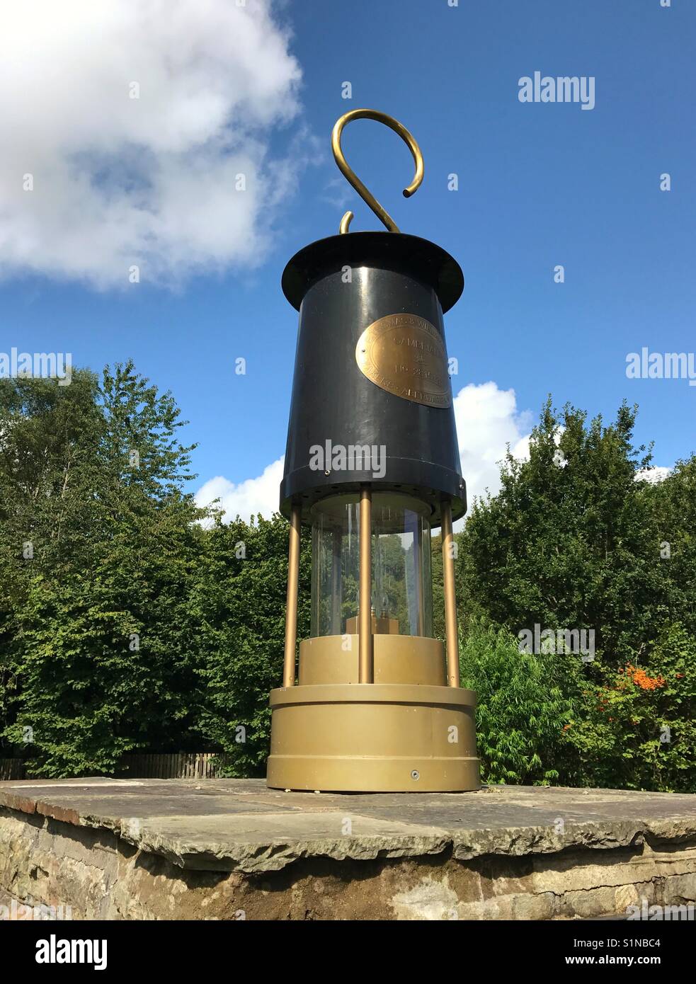 Large scale reproduction of a miner's lamp at the entrance to the Rhondda Heritage Park, which is located in the old Lewis Merthyr colliery Stock Photo