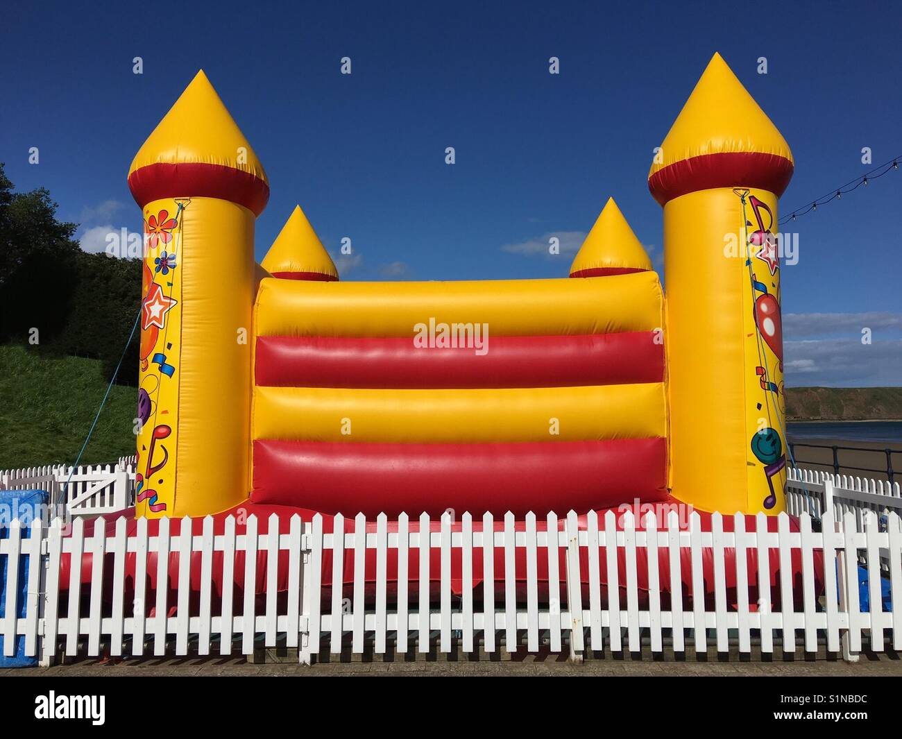 Red and yellow inflated bouncy castle Stock Photo - Alamy