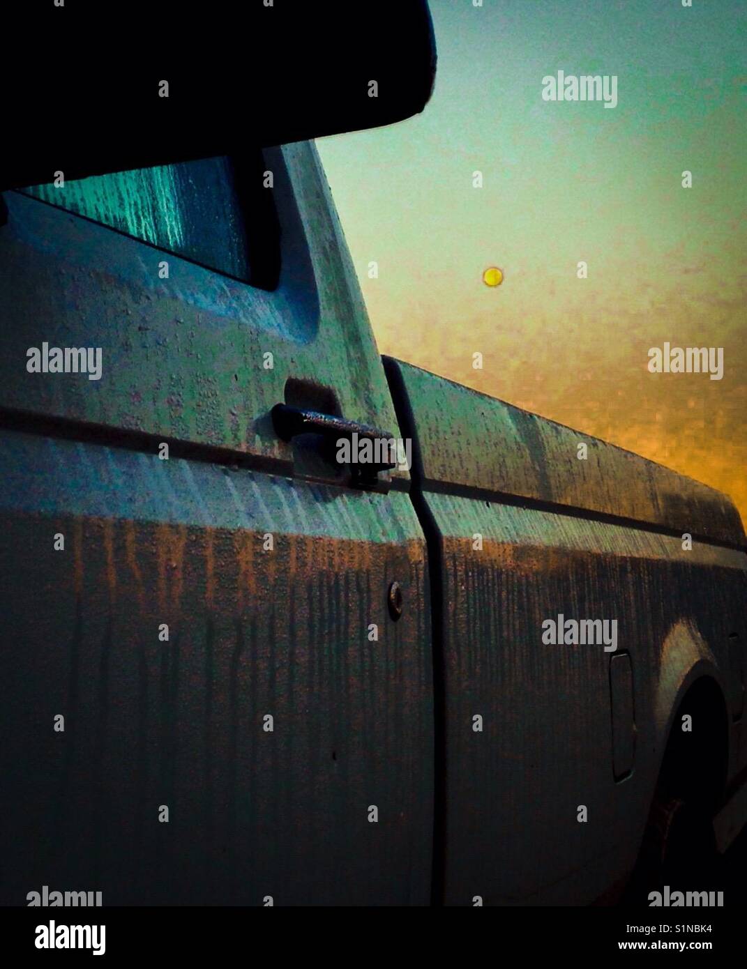 Full moon at morning light framed by pickup in North Carolina - Smartphone Captured Stock Image