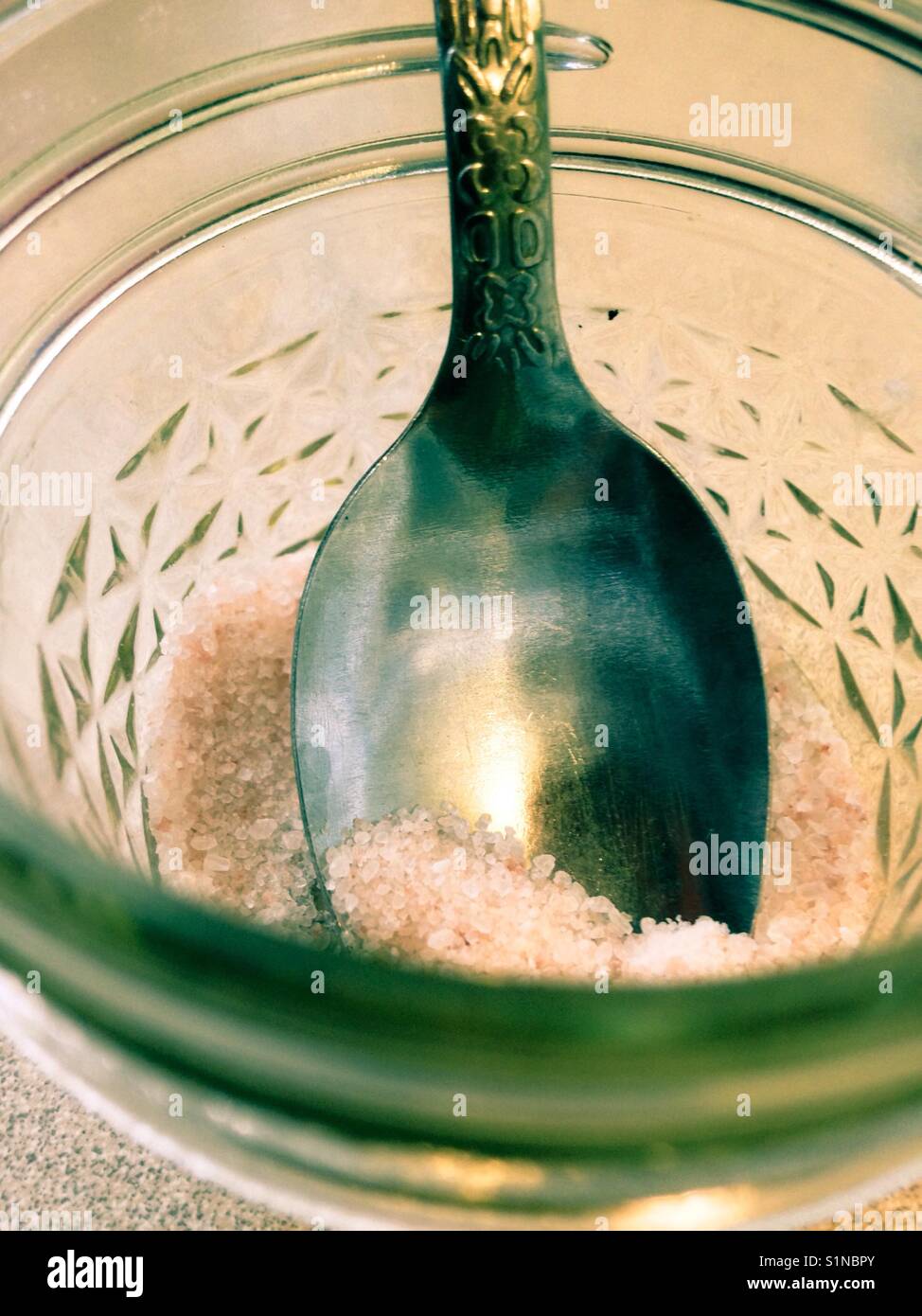Spoon and Himalayan salt inside small canning jar - Smartphone Captured Stock Image