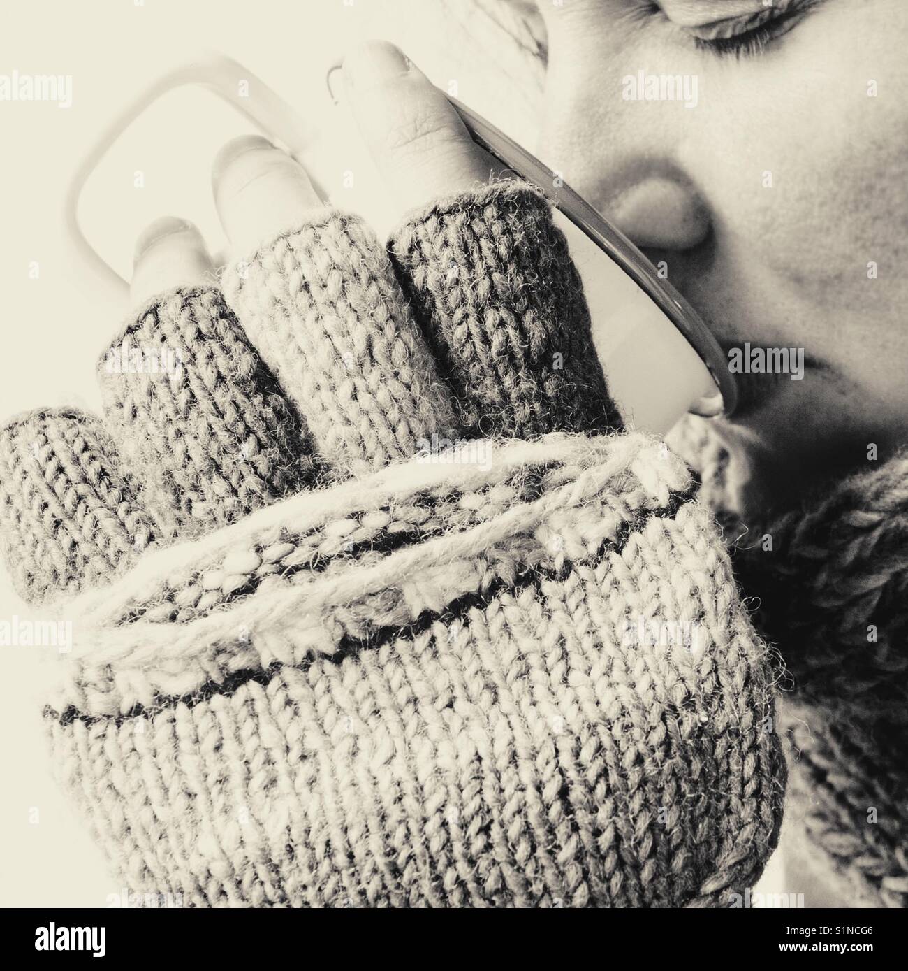 Portrait of a woman drinking from an enamel mug in winter - Smartphone Captured Stock Image