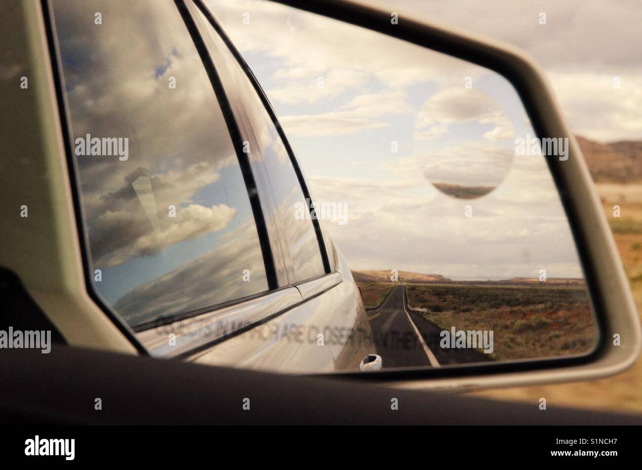 Landscape reflection in the rearview mirror of a car, New Mexico, USA - Smartphone Captured Stock Image