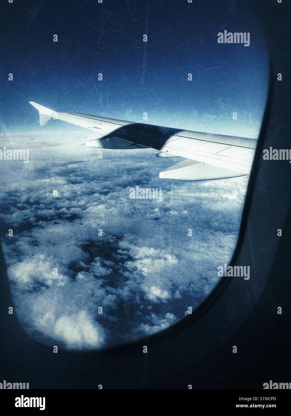 Airplane wing above the clouds Stock Photo - Alamy