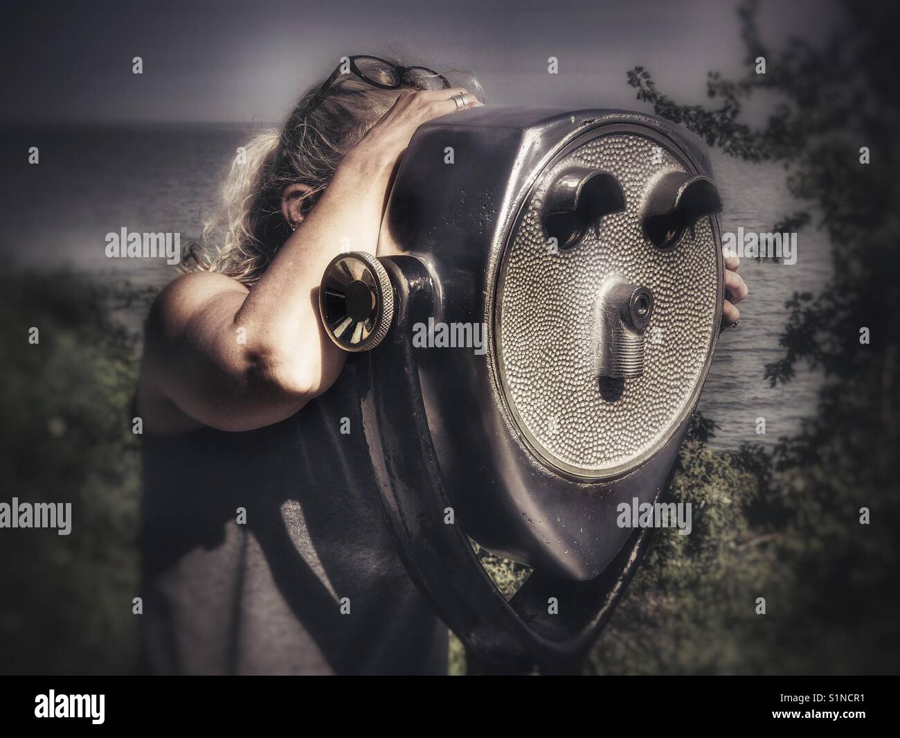 Woman looking through viewer at Lake Erie - Smartphone Captured Stock Image