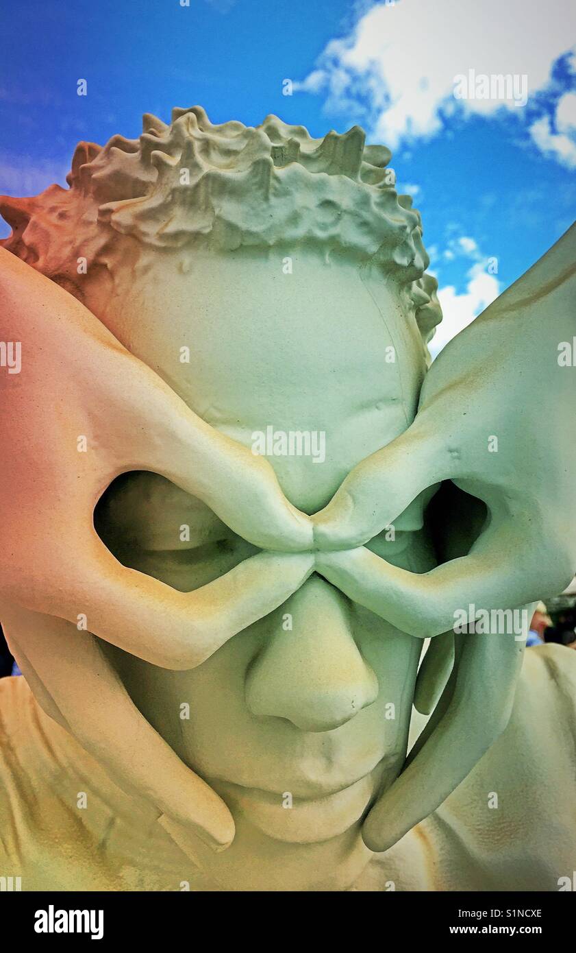 Statue of a man's head with hands simulating eyeglasses, USA. - Smartphone Captured Stock Image