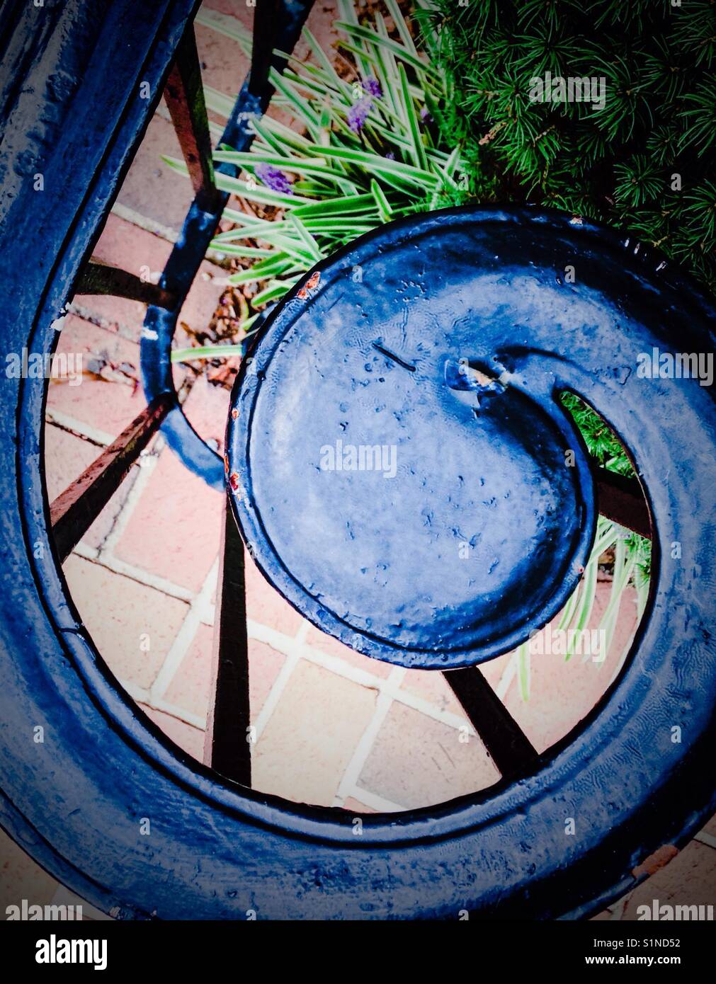 Curlicue in iron handrail and brick pavers - Smartphone Captured Stock Image