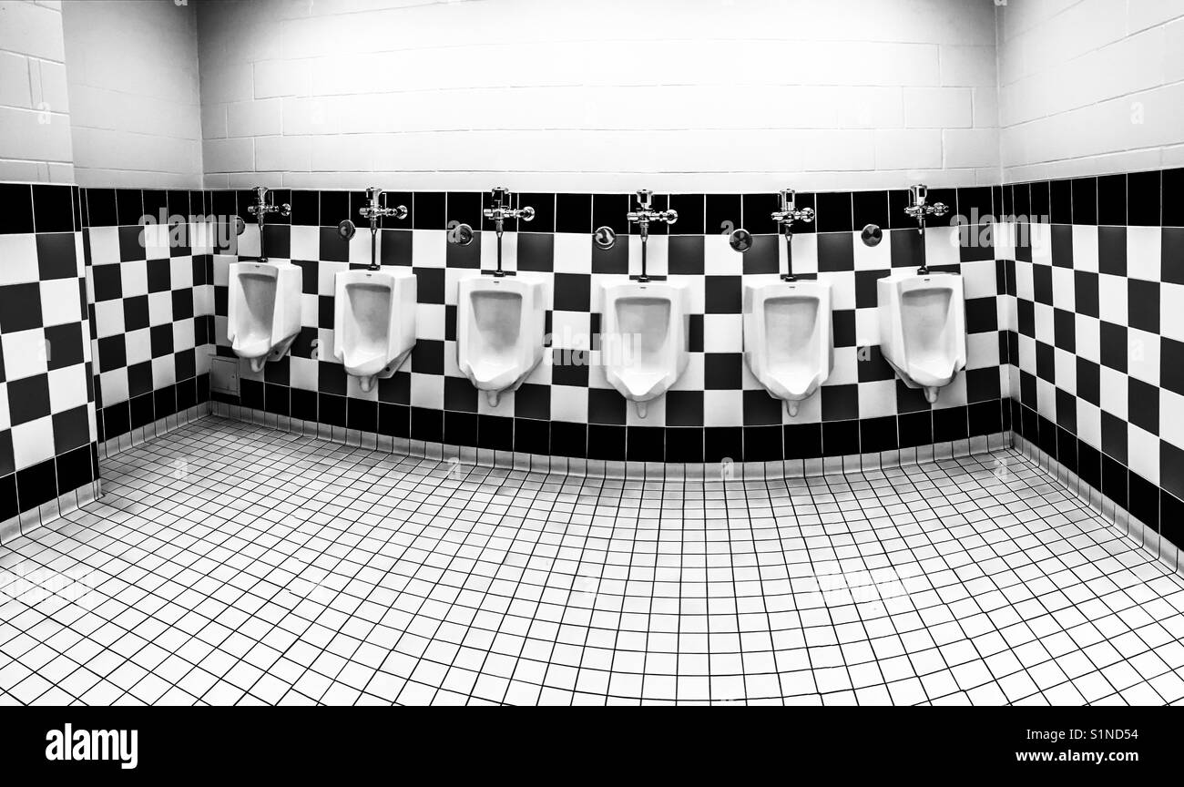 Six men's urinals in a checkered tile pattern - Smartphone Captured Stock Image