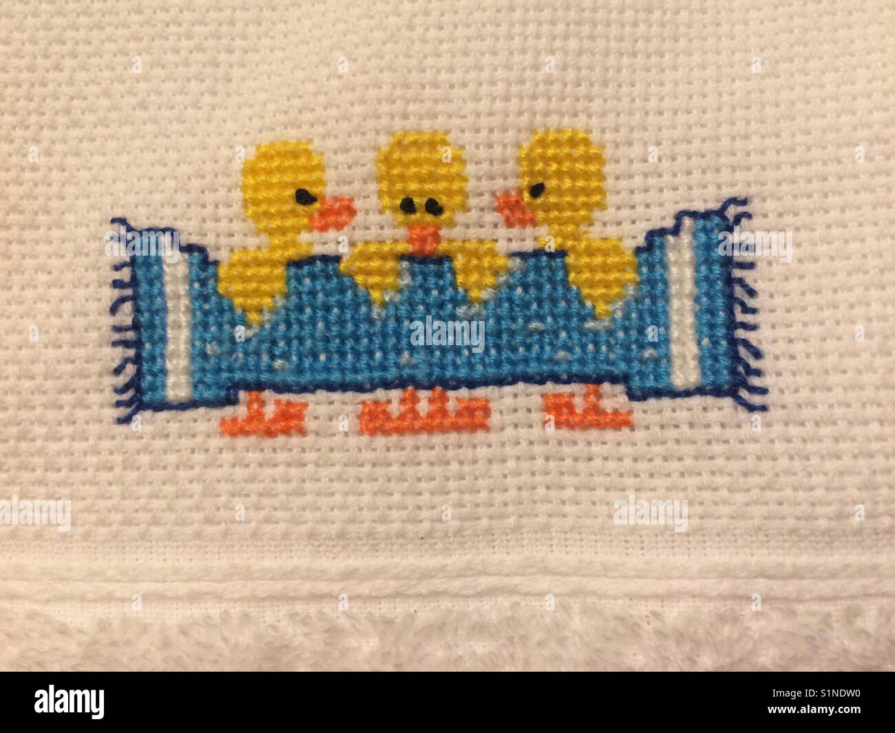 Cross stitch towel detail, ducks with towel. - Smartphone Captured Stock Image