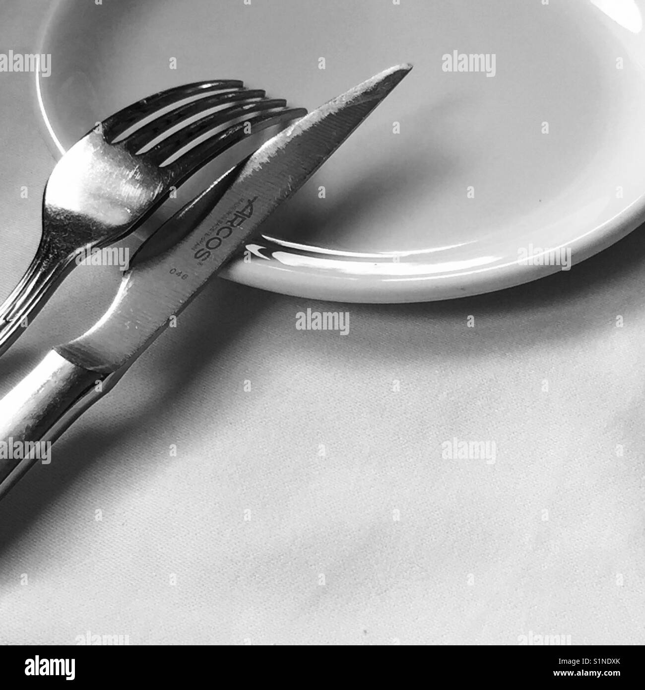 Fork and knife on plate. Stock Photo