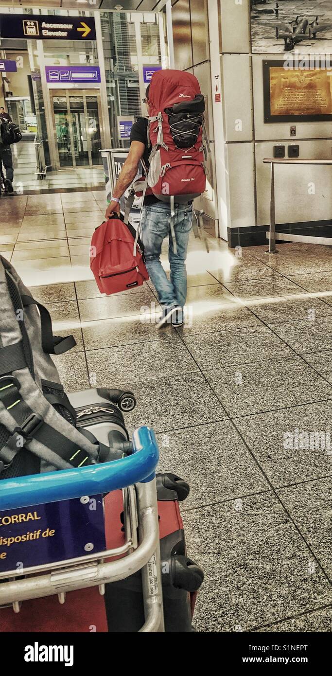 Passenger with baggage in an airport. Stock Photo