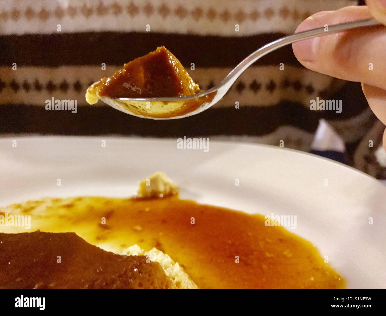 Spoonful of creme caramel. Close view. - Smartphone Captured Stock Image