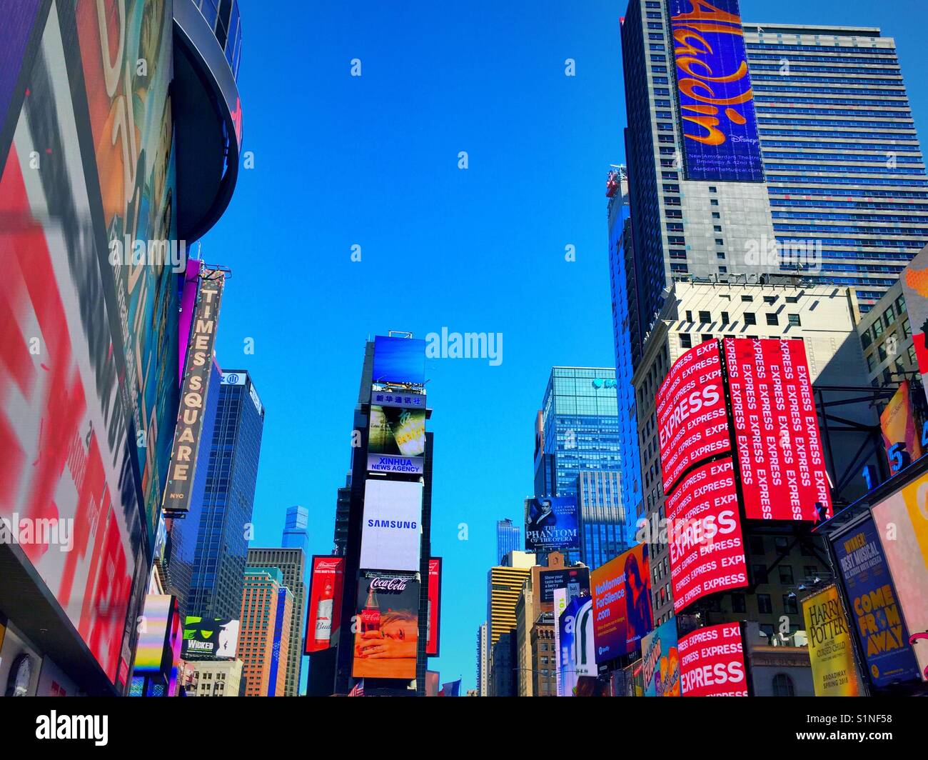 Skyscrapers in buildings in time square covered in advertisements and billboards, New York City, USA - Smartphone Captured Stock Image
