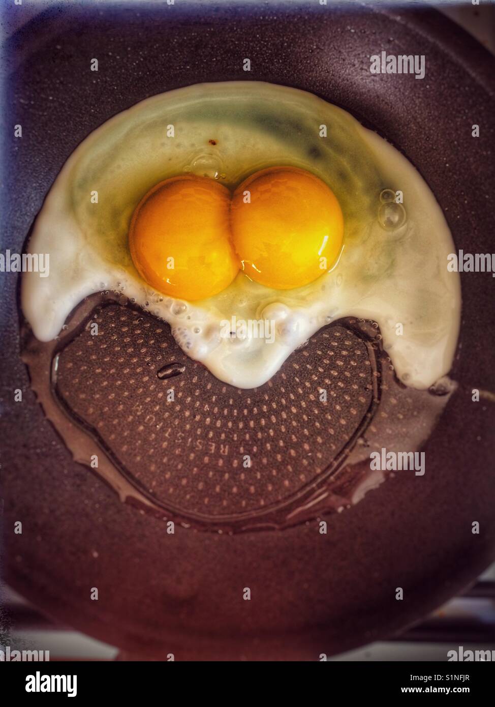 Double yolk egg frying - Smartphone Captured Stock Image