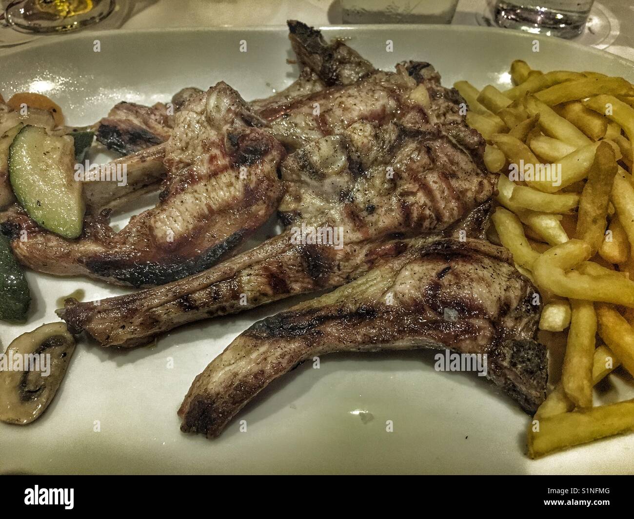 Grilled lamb chops and chips, typical Spanish meal Stock Photo