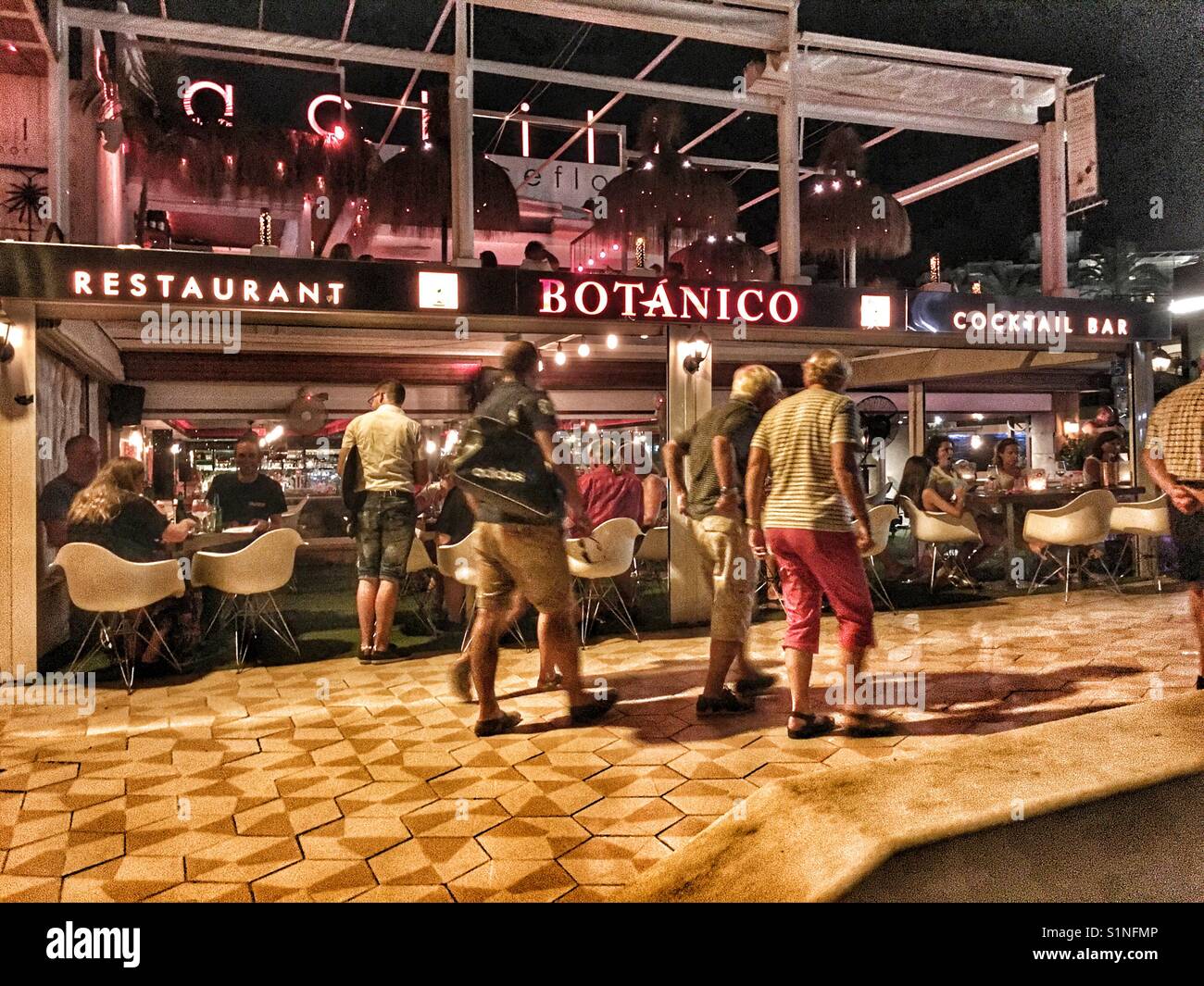Restaurant Botanico Cocktail Bar on the Arenal beach in Javea, Alicante, Spain. Nighttime with tourists. - Smartphone Captured Stock Image