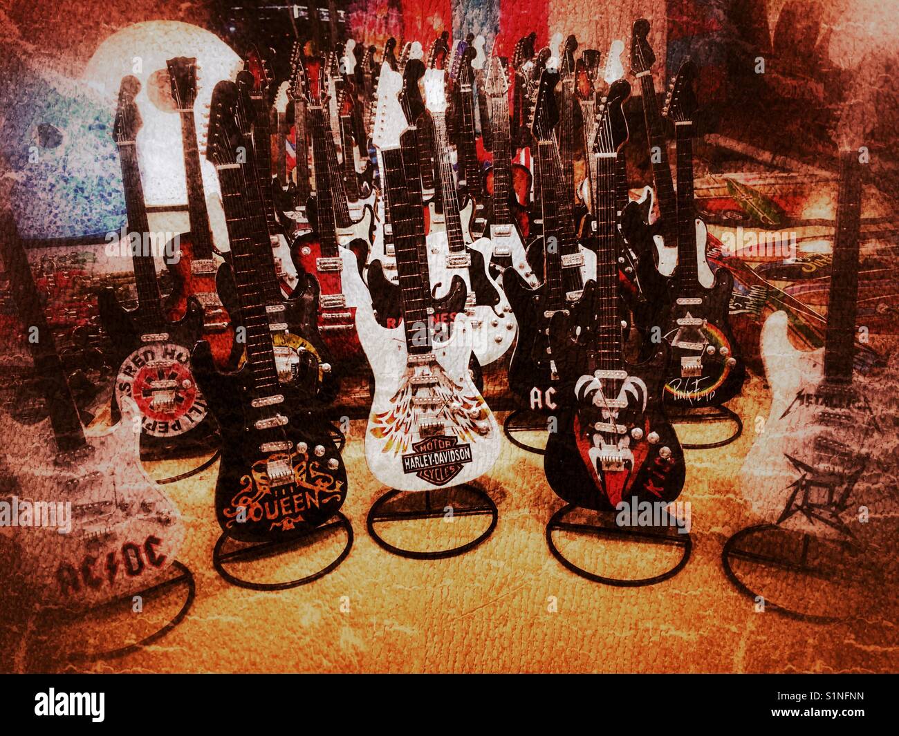 Miniature electric guitar ornaments for sale at night market on the Arenal Beach, Javea, Alicante, Spain - Smartphone Captured Stock Image