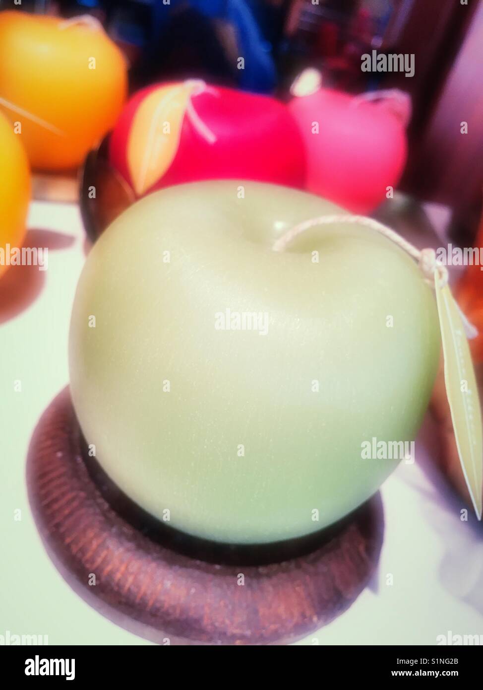 Wax candle in the shape of a green apple, USA - Smartphone Captured Stock Image