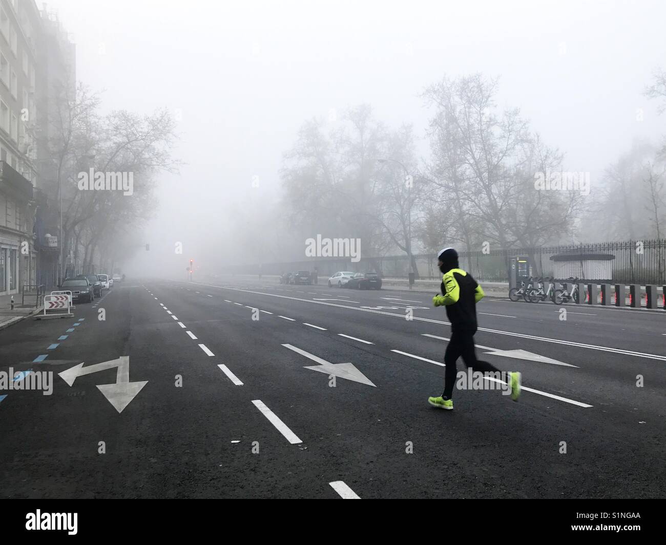 Man running in the mist. Madrid. Spain. - Smartphone Captured Stock Image