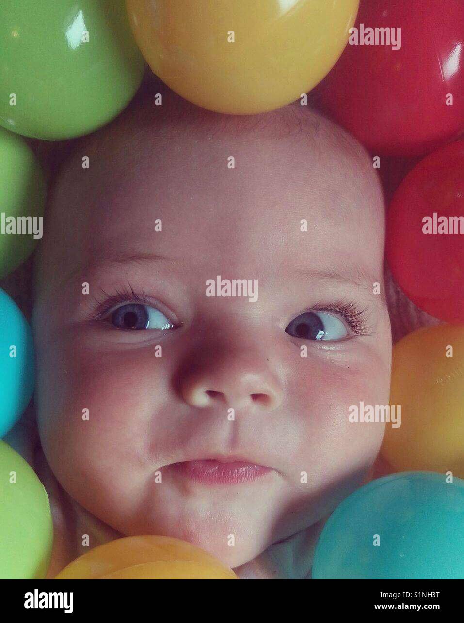 Baby playing in ball pit Stock Photo Alamy