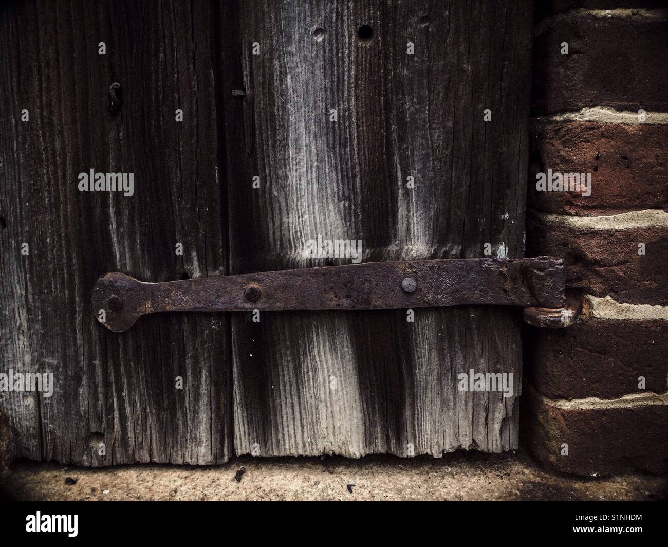 Rusty hinges on really old door - Smartphone Captured Stock Image