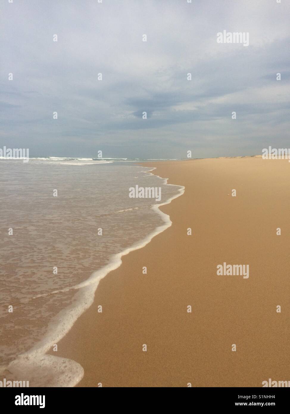 Waves washing up onto beach - Smartphone Captured Stock Image