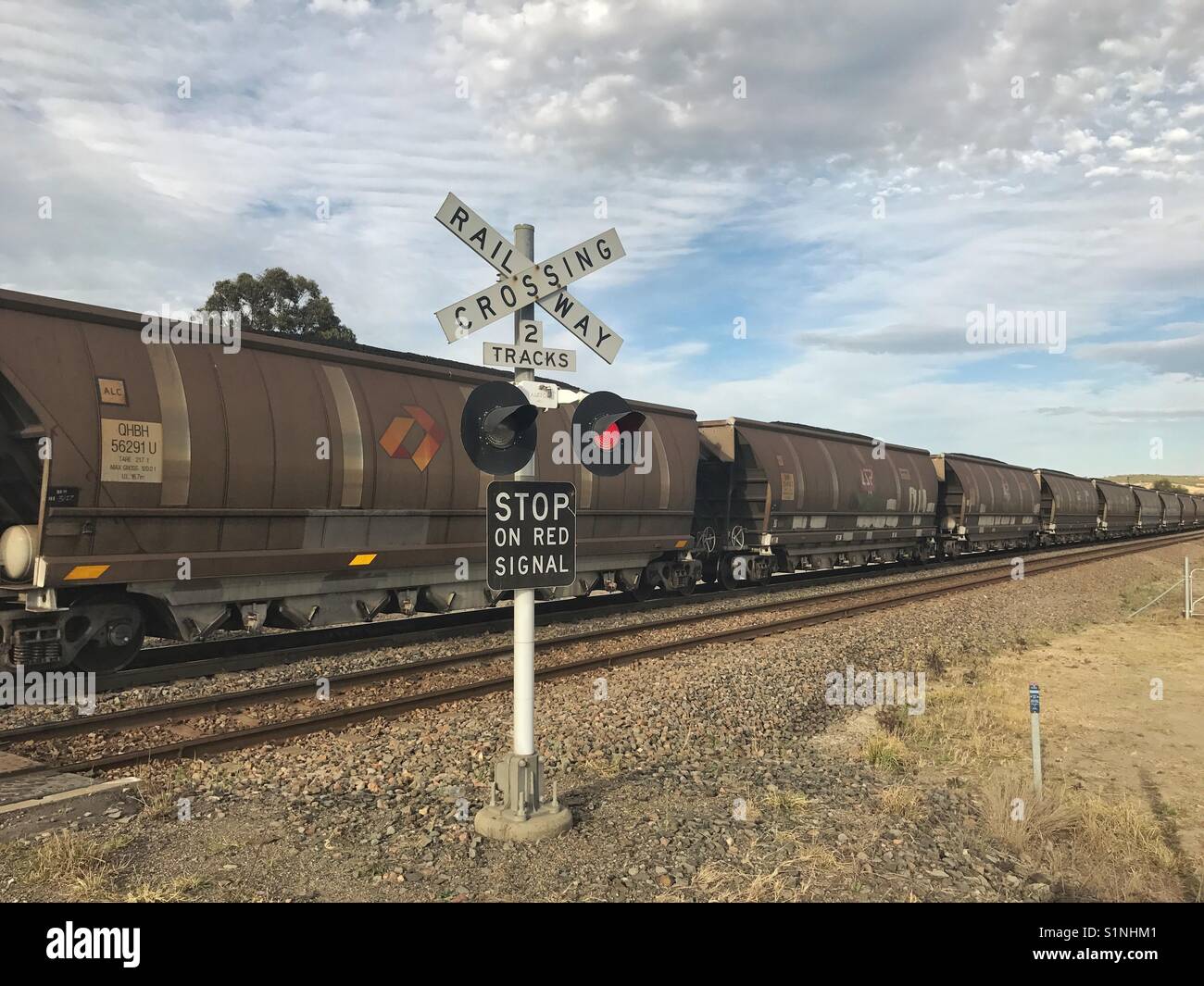 Coal train at railway crossing - Smartphone Captured Stock Image