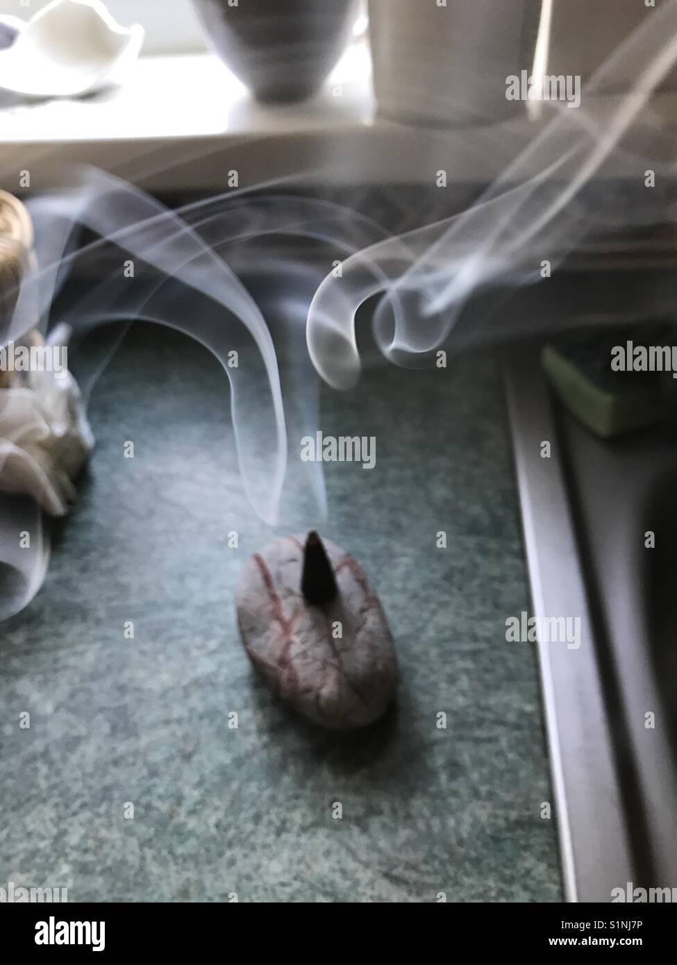 Smoking incense in a kitchen - Smartphone Captured Stock Image