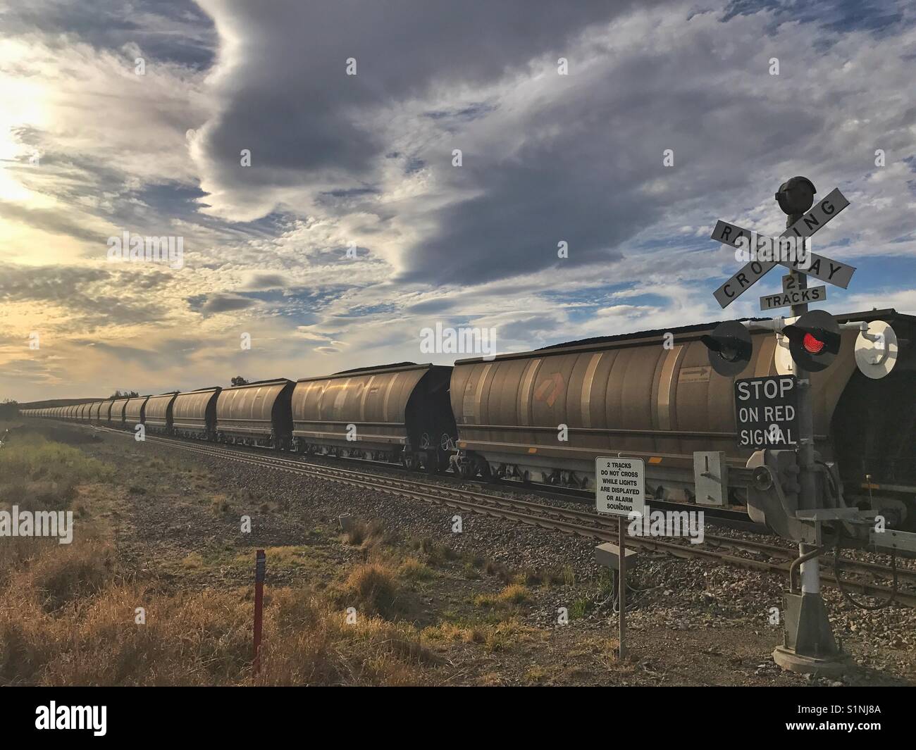 Long coal train at crossing - Smartphone Captured Stock Image