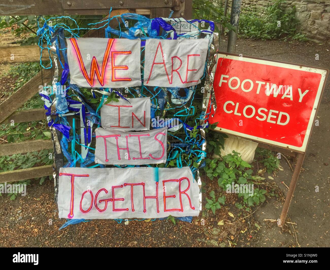 We are in this together and footway closed signs in Bristol, England Stock Photo