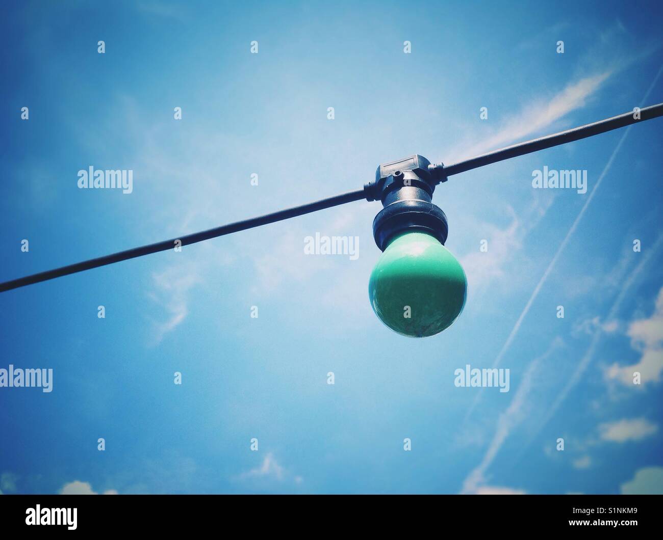 Light bulb against blue sky - Smartphone Captured Stock Image