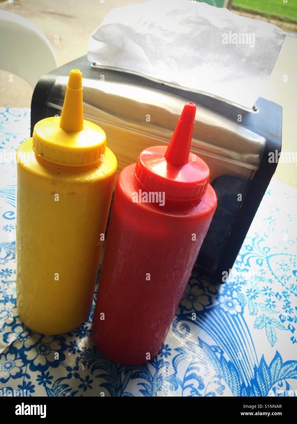 Condiments and napkin holder on outdoor café table, USA Stock Photo - Alamy