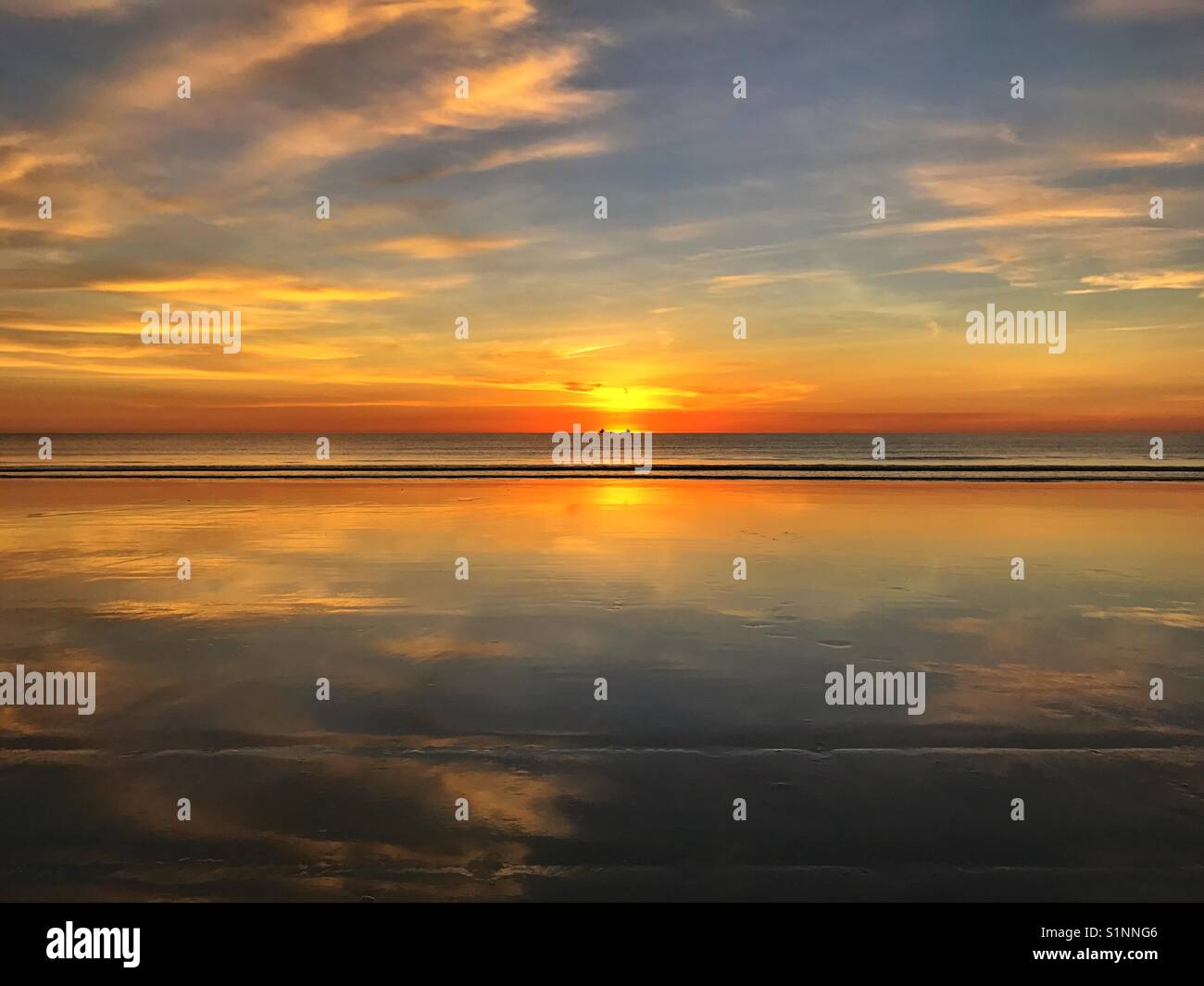 Mirror image sunset on beach - Smartphone Captured Stock Image