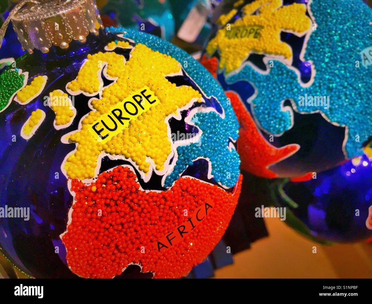 Globe Christmas ornaments on display at Macy’s Christmas tree Lane, NYC