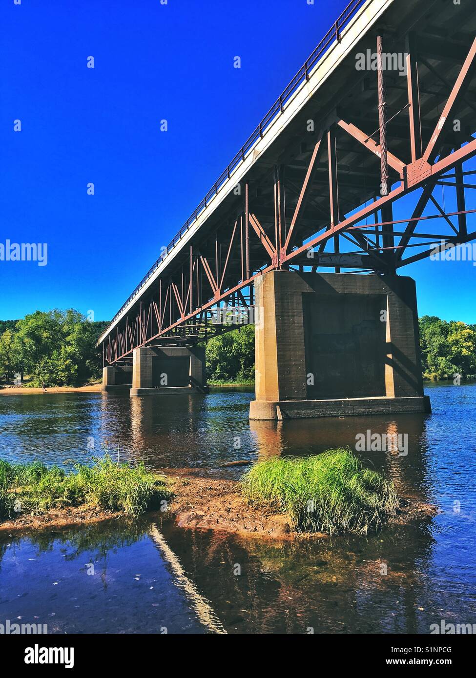Metal bridge across a river Stock Photo Alamy