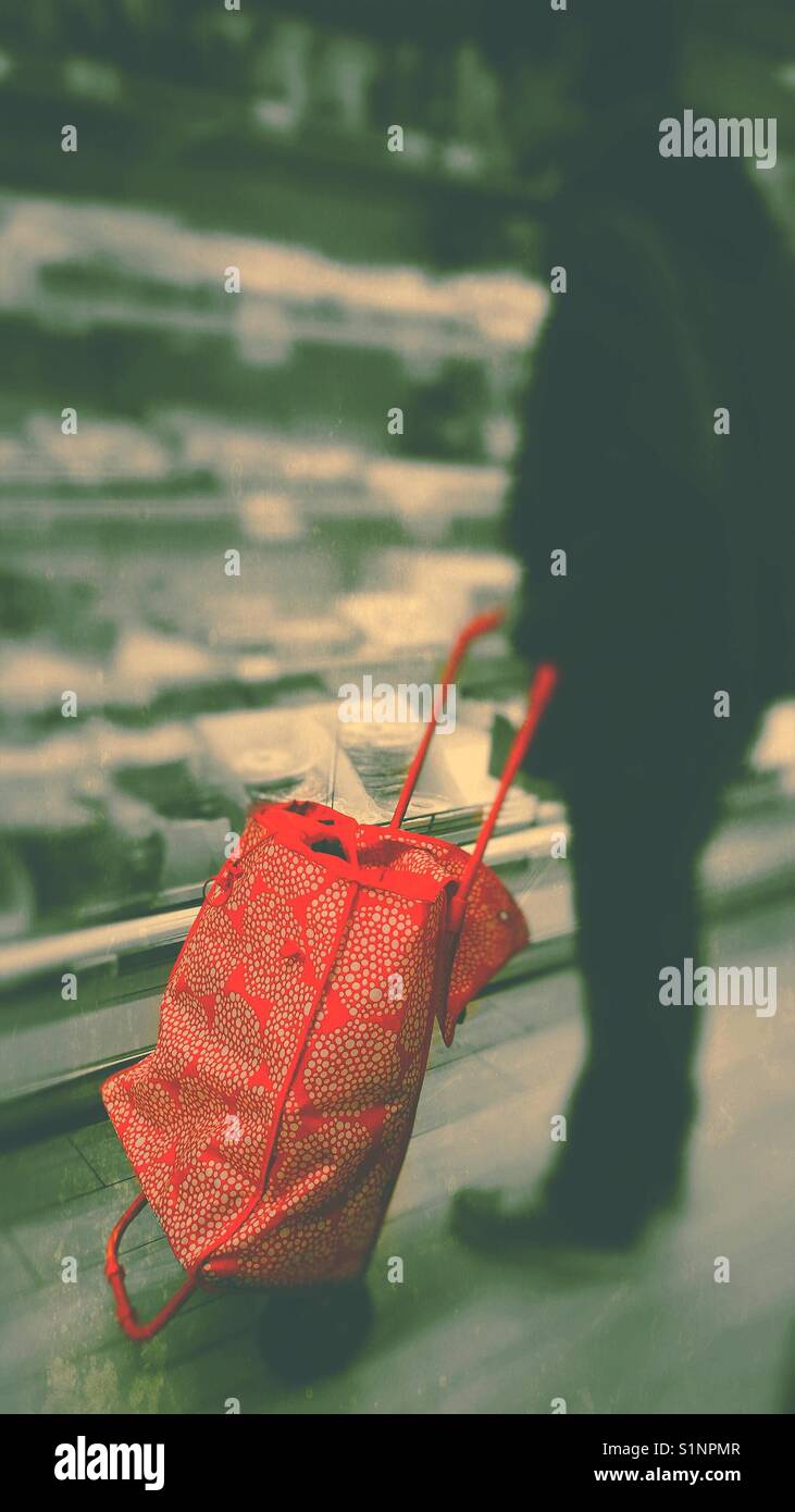 Man with red shopping trolley in supermarket looking at a fridge - Smartphone Captured Stock Image